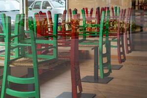 restaurant with a lot of green and red chairs photo