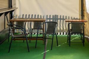 table and chairs are set up on a green carpeted area photo