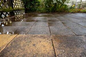 wet old paving slabs in a house driveway photo