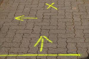 yellow arrows on a footpath photo