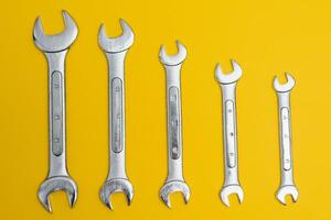 new wrenches on a yellow background. photo