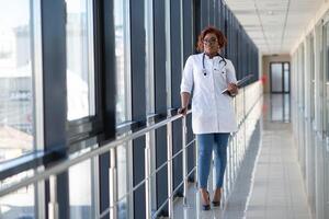 portrait of pretty african medical doctor. african american doctor in modern clinic photo