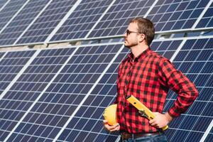 Worker installing solar panels outdoors photo