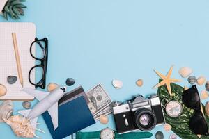 Travel accessories on blue background, travel concept. Top view with copy space photo