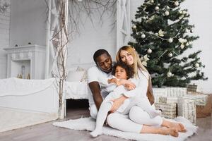 happy multiracial family with gifts at Christmas photo