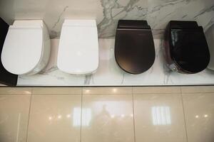 samples of modern sanitary ware for the toilet. new modern toilet in the plumbing store photo