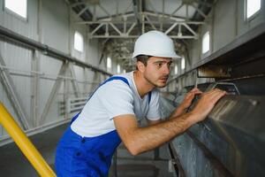 Portrait of factory worker. Young handsome factory worker. photo