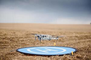 Drone flying during the day in field. The use of drones in the agricultural business photo