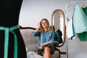 Fashion designer working on her designs in the studio photo