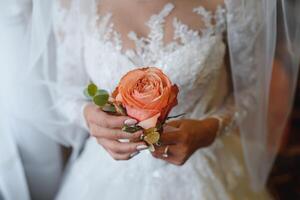 Bride and groom holding rose close up photo