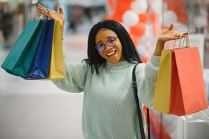 Beautiful shopping woman smiling and holding bags. photo