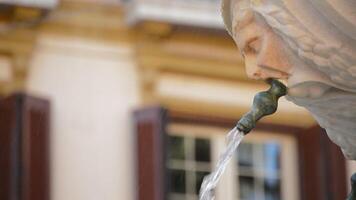 Sculpted face mouth in fountain pouring water video