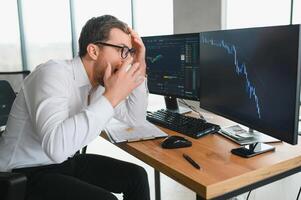 Stressed business man crypto trader broker investor analyzing stock exchange market crypto trading decreasing chart data fall down loss, desperate about losing money of crisis, recession, inflation. photo