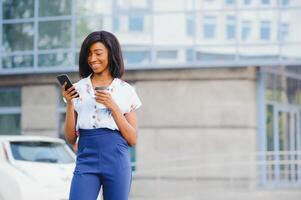 A pretty African american business woman talking on a cell phone at office building photo