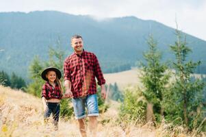 Happy father and little child are walking in the mountains. Father's Day. vacation in the national park photo