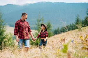 Happy father and little child are walking in the mountains. Father's Day. vacation in the national park photo