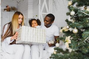 happy multiracial family with gifts at Christmas photo