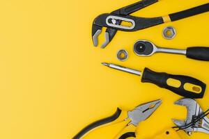 Set of various construction tools. Tools for home repair. Work at a construction site. On a yellow background. Flatly. Flatlay photo