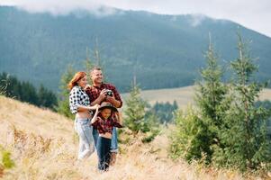 Young family with child resting on a mountain. vacation in the national park photo