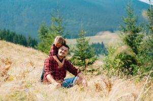 Happy father and little child are walking in the mountains. Father's Day. vacation in the national park photo