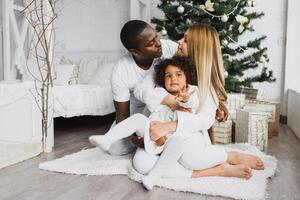 happy multiracial family with gifts at Christmas photo