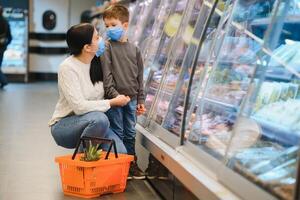Mother and son in face mask in shopping mall photo