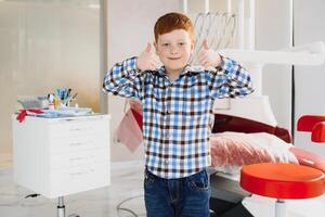 Boy satisfied with the service in the dental office. concept of pediatric dental treatment photo