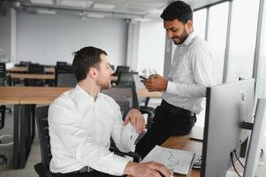 Two diverse crypto traders brokers stock exchange market investors discussing trading charts research reports growth using pc computer looking at screen analyzing invest strategy, financial risks. photo