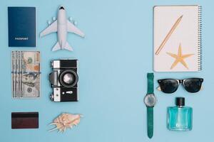 Travel accessories on blue background, travel concept. Top view with copy space photo