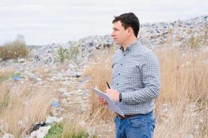 Nature conservation concept. A man studies the pollution of nature. Keeping the environment clean. Ecological problems. Recycling photo