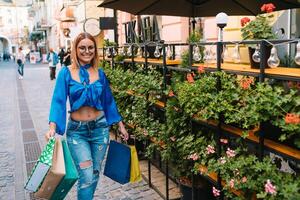 Woman in shopping. Happy woman with shopping bags enjoying in shopping. Consumerism, shopping, lifestyle concept photo