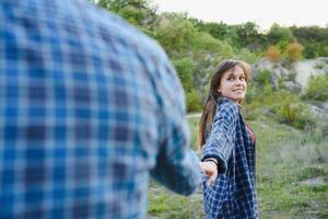 Couple in love rest on green hill in country side photo