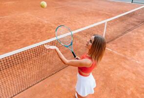 Woman in sportswear plays tennis at competition photo