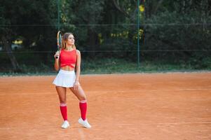 girl tennis player is training on the court photo