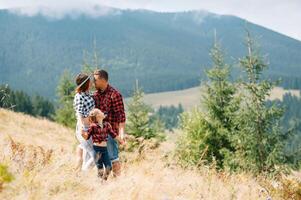 Young family with child resting on a mountain. vacation in the national park photo