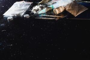 Hard drugs on dark table. photo