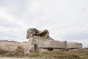 the ruins of german bunker in the beach of Normandy, France photo