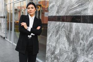 Attractive young woman in the city. Business lady photo