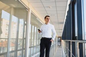 Businessman walking in the hall entrance photo