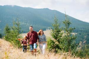 Young family with child resting on a mountain. vacation in the national park photo