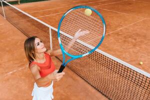 Woman in sportswear plays tennis at competition photo