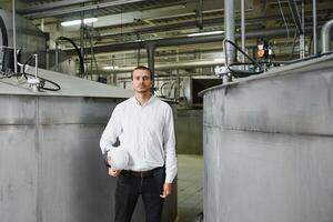 happy male industrial technician inside a factory photo