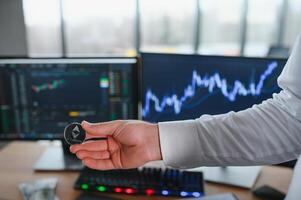 View of hand holding a bitcoin and giving it to other people. Cryptocurrency trading concept photo