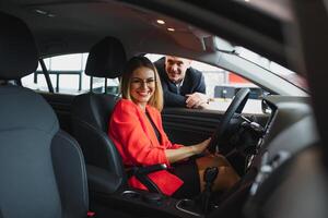 mujer comprando el coche y vendedor de venta foto