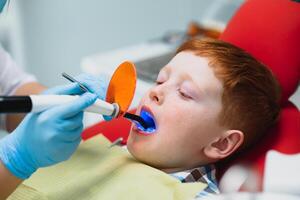 Female dentist and child in a dentist office photo