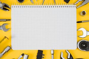 Carpenter tools set on yellow background, top view. photo