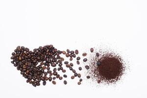 Heart made of coffee beans and ground coffee isolated on white background photo