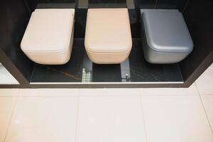 samples of modern sanitary ware for the toilet. new modern toilet in the plumbing store photo