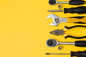 Set of various construction tools. Tools for home repair. Work at a construction site. On a yellow background. Flatly. Flatlay photo