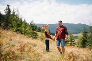 Happy father and little child are walking in the mountains. Father's Day. vacation in the national park photo